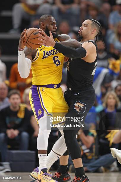 LeBron James of the Los Angeles Lakers handles the ball against Dillon Brooks of the Memphis Grizzlies during the second half of Game Two of the...