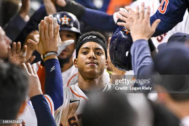 Jeremy Pena of the Houston Astros celebrates in the dugout after hitting a three-run home run in the eighth inning against the Toronto Blue Jays at...