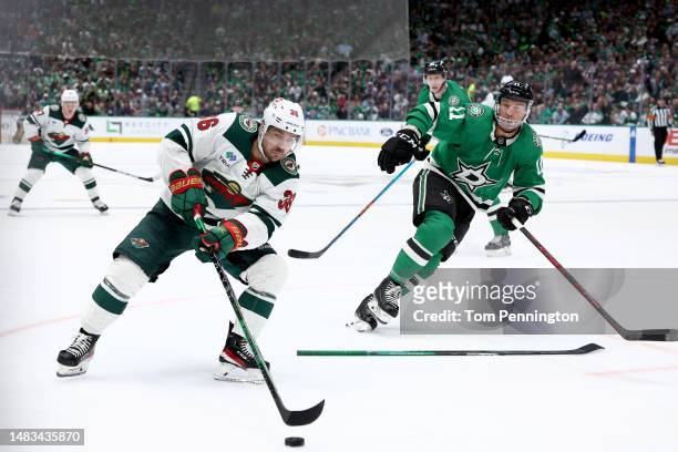 Mats Zuccarello of the Minnesota Wild controls the puck against Luke Glendening of the Dallas Stars in the second period in Game Two of the First...