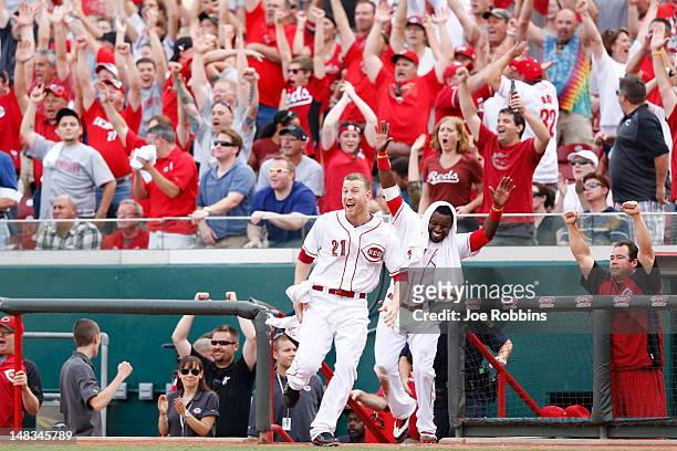 Todd Frazier and Brandon Phillips of the Cincinnati Reds celebrate after Ryan Ludwick , hit the game-winning home run in the tenth inning against the...