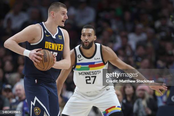 Nikola Jokic of the Denver Nuggets directs the offence while being guarded by Rudy Gobert of the Minnesota Timberwolves in the second quarter during...