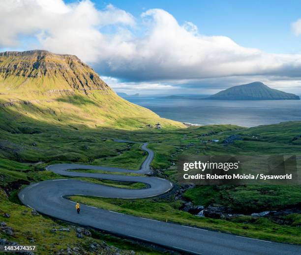 aerial view of hiker standing in the middle of a road - nordeuropäischer abstammung stock-fotos und bilder