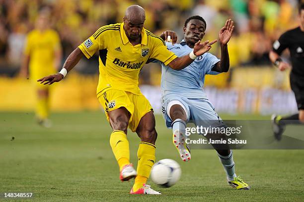Peterson Joseph of Sporting Kansas City attempts to defend as Emilio Renteria of the Columbus Crew attempts a shot in the first half on July 14, 2012...