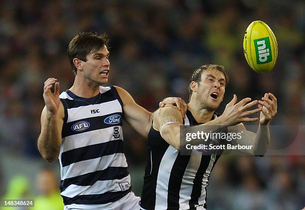 Ben Reid of the Magpies and Tom Hawkins of the Cats compete for the ball during the AFL Round 16 game between the Geelong Cats and the Collingwood...