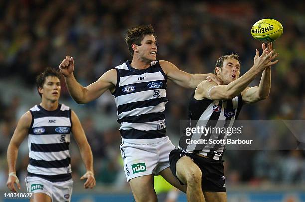 Ben Reid of the Magpies and Tom Hawkins of the Cats compete for the ball during the AFL Round 16 game between the Geelong Cats and the Collingwood...