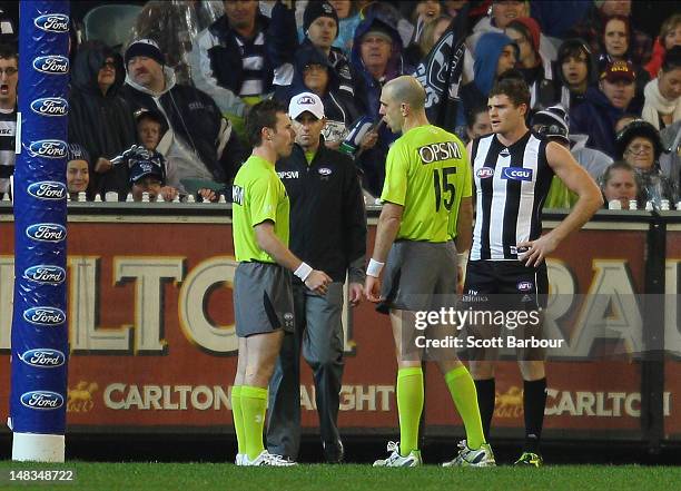 Umpire Matthew Nicholls waits for the the video review system decision during the AFL Round 16 game between the Geelong Cats and the Collingwood...