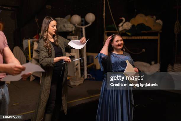 young woman with down syndrome practicing her lines with her colleagues before a performance - rehearsing lines stock pictures, royalty-free photos & images