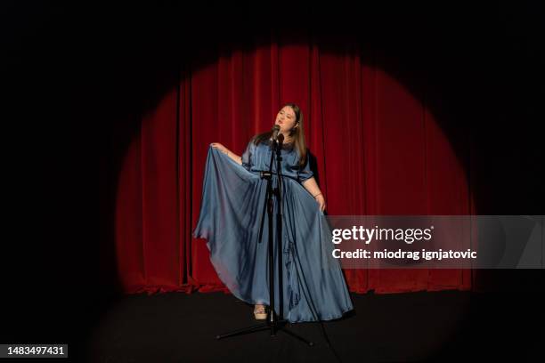 young woman with down syndrome acting in the theatre - blue dress stock pictures, royalty-free photos & images