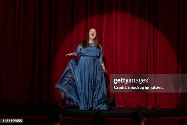 young woman with down syndrome acting in the theatre - opera singer stock pictures, royalty-free photos & images