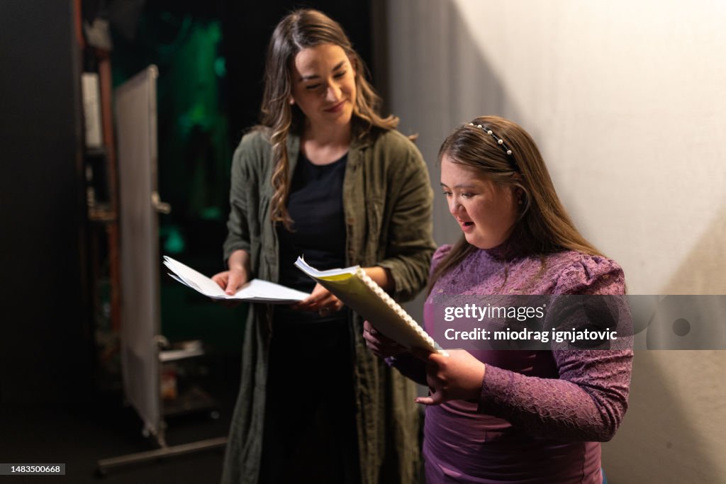 Young woman with down syndrome having acting lesson with a teacher