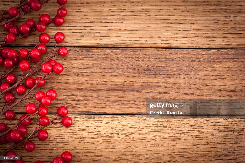 Holly berry on wooden background