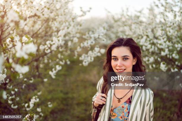 spring portrait of beautiful young woman in blossoming orchard - april 22 stock pictures, royalty-free photos & images