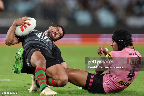 Cody Walker of the Rabbitohs is tackled by Stephen Crichton of the Panthers during the round eight NRL match between South Sydney Rabbitohs and...
