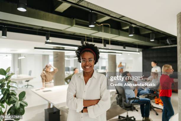 portrait of a young african-american woman in her office - young professional stock pictures, royalty-free photos & images