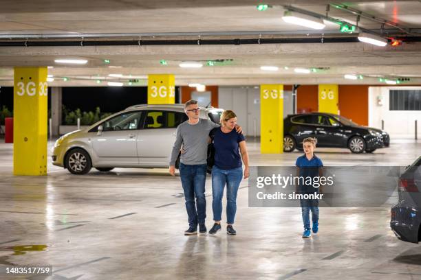 family walking in parking space - parking space stock pictures, royalty-free photos & images