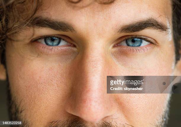 blue-eyed man. - extreme close up face stock pictures, royalty-free photos & images