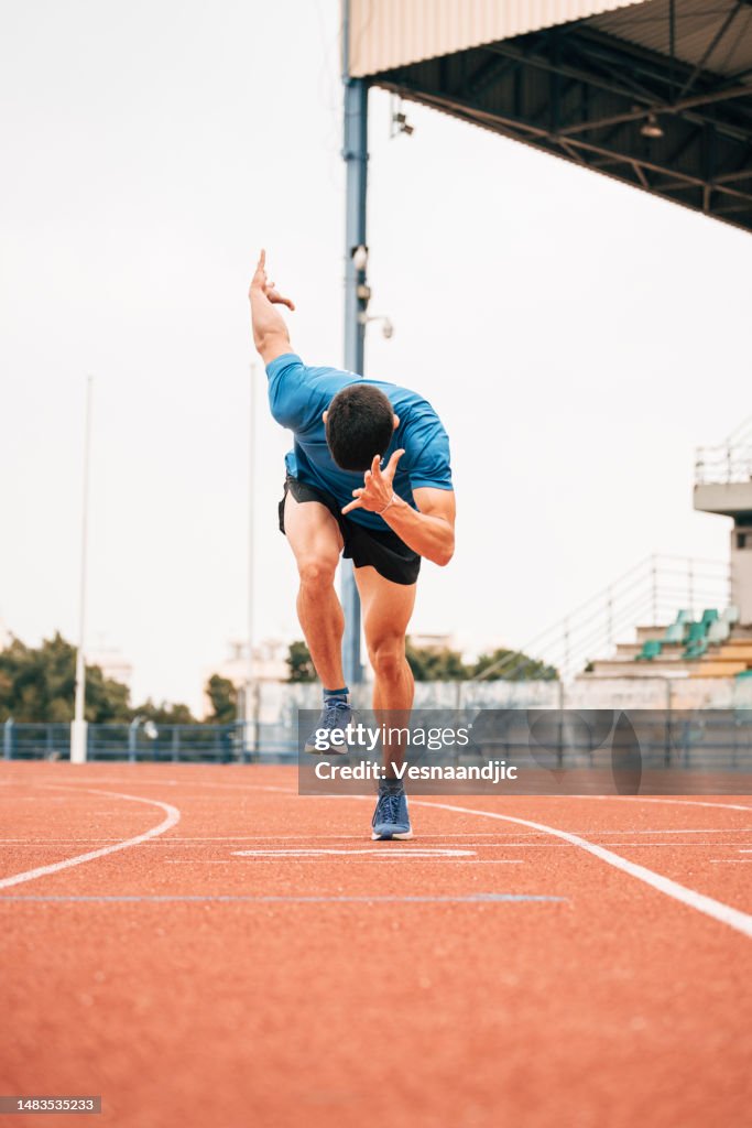 Young man athlete, track runner