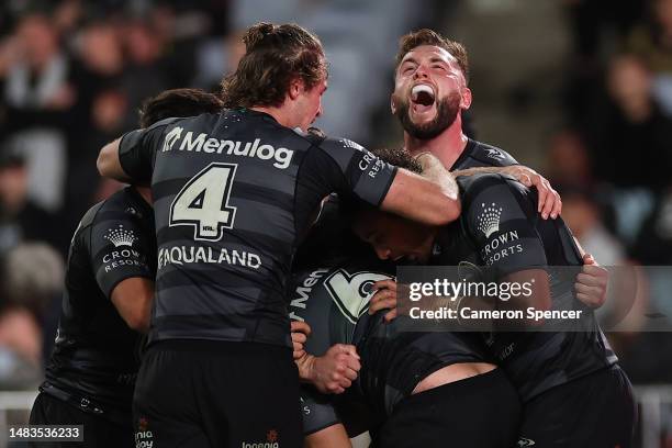 Isaiah Tass of the Rabbitohs celebrates with team mates after scoring a try during the round eight NRL match between South Sydney Rabbitohs and...