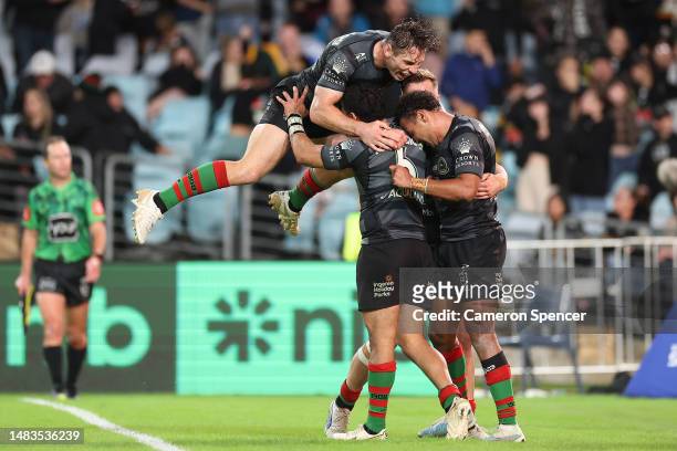 Isaiah Tass of the Rabbitohs celebrates with team mates after scoring a try during the round eight NRL match between South Sydney Rabbitohs and...