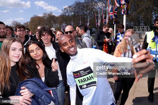 Sir Mo Farah takes a selfie with a fan ahead of the 2023 TCS London Marathon on April 20, 2023 in London, England.