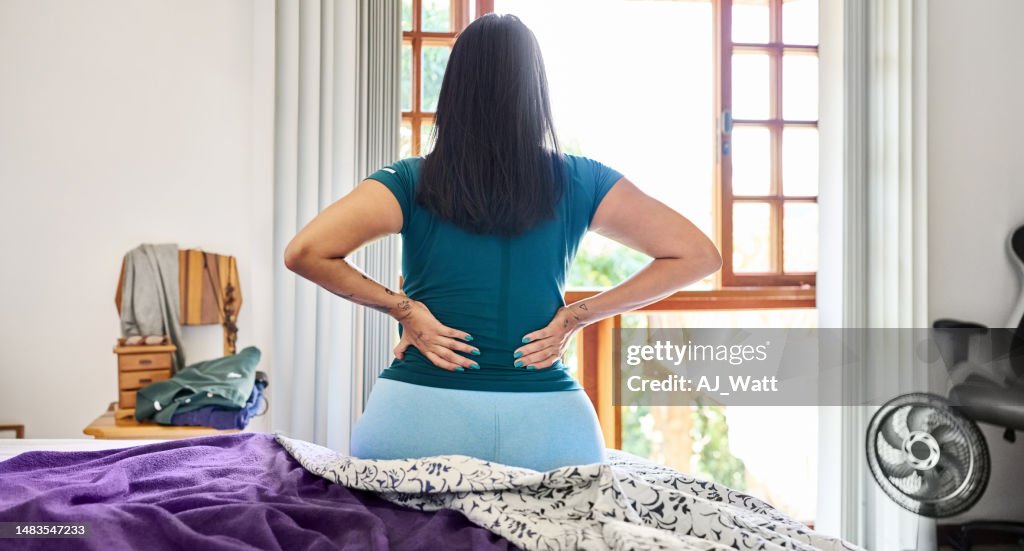 Woman waking up in the morning suffering backache