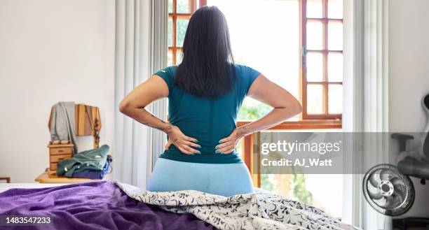 woman waking up in the morning suffering backache - back pain bed stock pictures, royalty-free photos & images