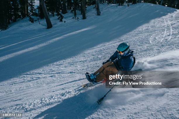 adaptive athlete sit-skiing on sunny winter day - disabled skier stock pictures, royalty-free photos & images