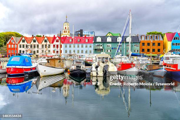 boats moored in the harbor of torshavn, denmark - faroe islands photos et images de collection