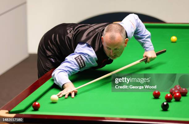 Mark Williams of Wales plays a shot during their round two match against Luca Brecel of Belgium on Day Six of the Cazoo World Snooker Championship...