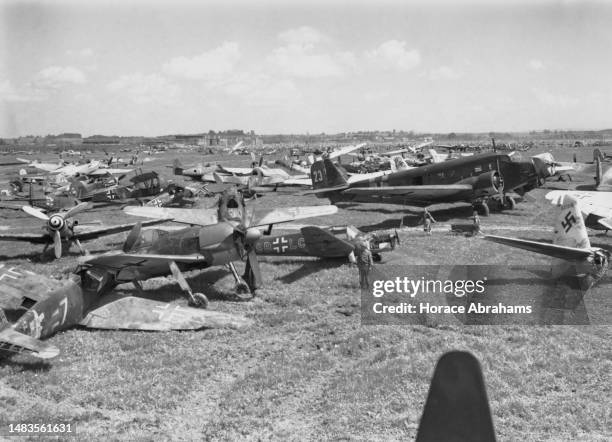 Soldiers from the Third Infantry Division of the United States Seventh Army examine captured and damaged Luftwaffe aircraft including Focke Wulf 190...