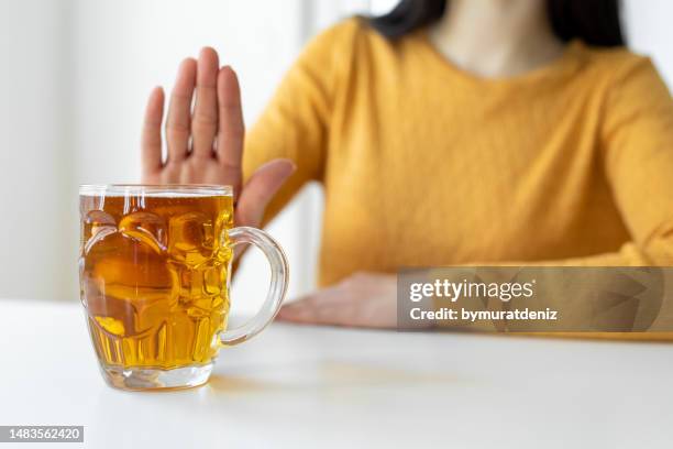 woman alcoholic social problems concept sitting refusal of alcohol - weigeren stockfoto's en -beelden