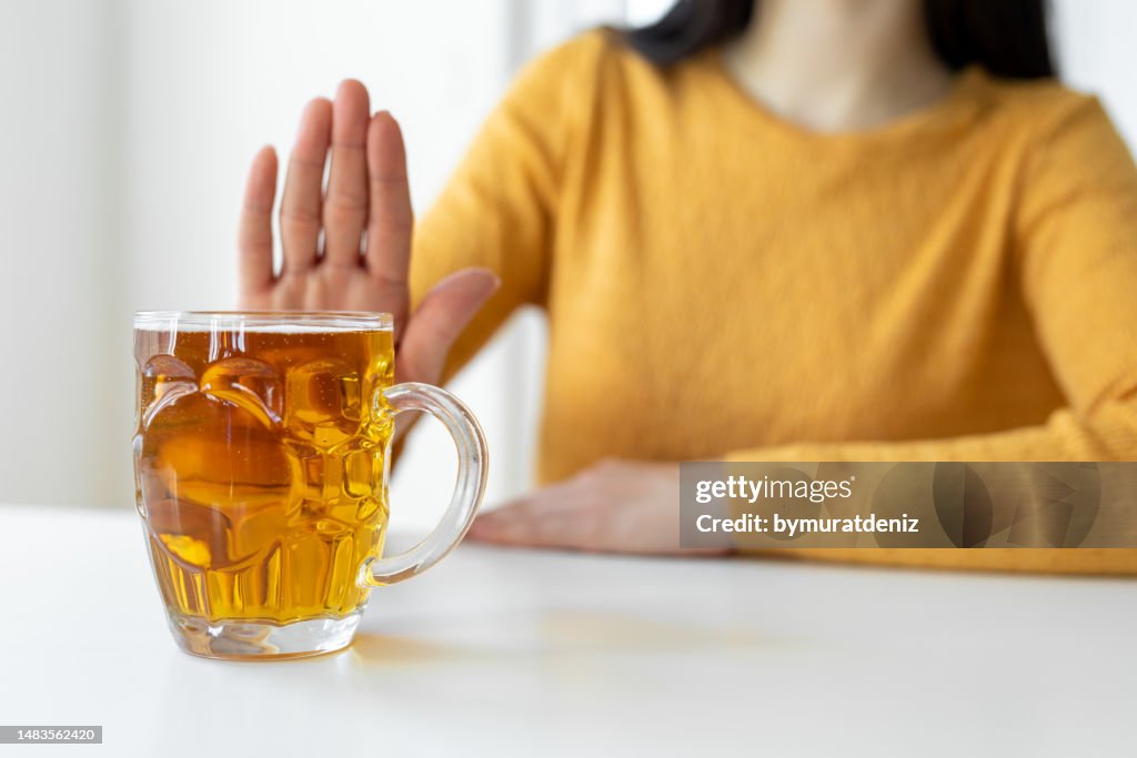 Woman alcoholic social problems concept sitting refusal of alcohol
