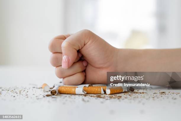 quitting smoking - breaking cigarette stock pictures, royalty-free photos & images