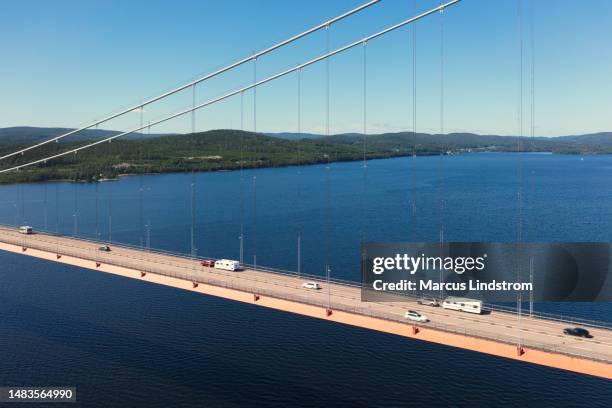 cars with camper trailers crossing the high coast bridge in summer - höga kusten bildbanksfoton och bilder