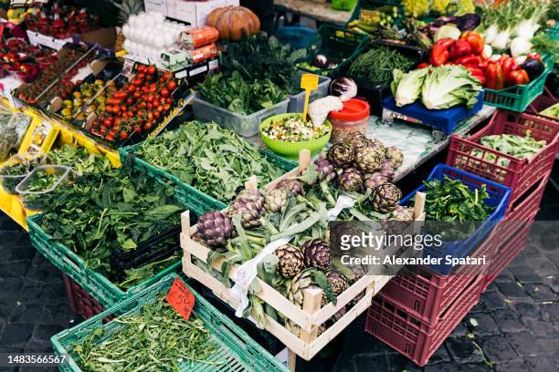 fresh vegetables and greens at the market stall for sale at campo de fiori, rome, italy - campo de fiori stock pictures, royalty-free photos & images