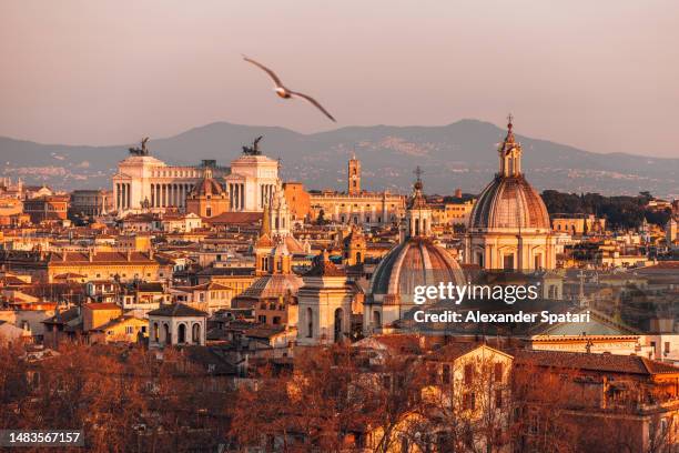 rome cityscape lit by the sun at sunset, high angle view, italy - rome italy stock pictures, royalty-free photos & images