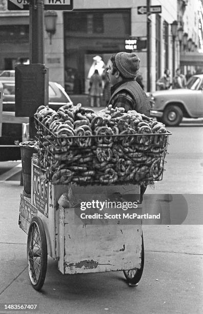 View of a pretzel vendor as he stands next to his cart on 5th Avenue , New York, New York, December 30, 1972.