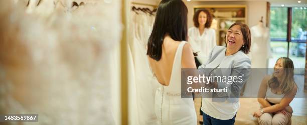 choosing the wedding dress with mum - wedding dress store stock pictures, royalty-free photos & images