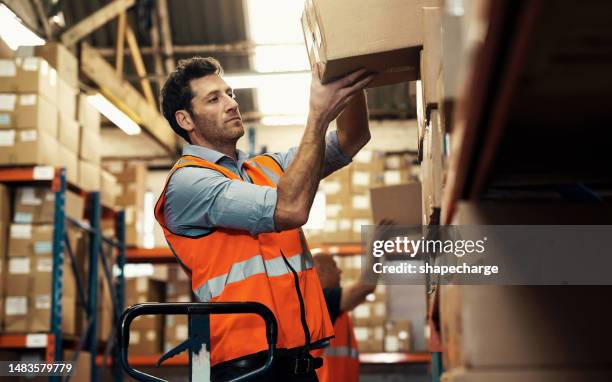 warehouse, box and man taking package from shelf, inventory or industrial stock. worker, person or employee lifting boxes for logistics, storage or distribution for shipping, cargo and supply chain. - shelf strip stock pictures, royalty-free photos & images