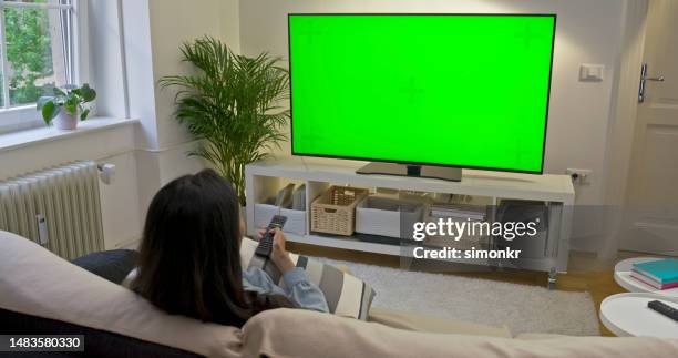 woman watching tv - alter tv stock pictures, royalty-free photos & images
