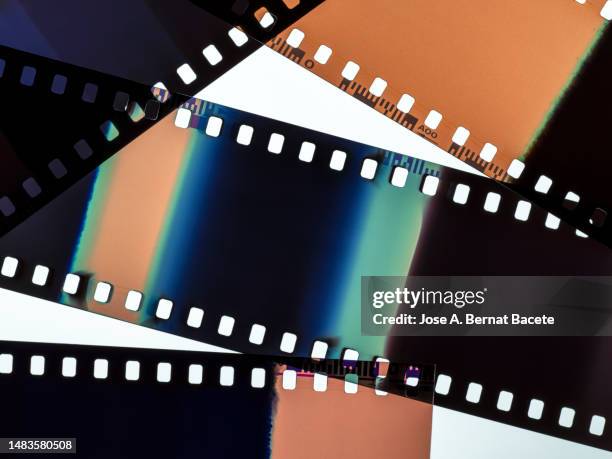 color negative 35mm film stripes on a white background. - film set bildbanksfoton och bilder