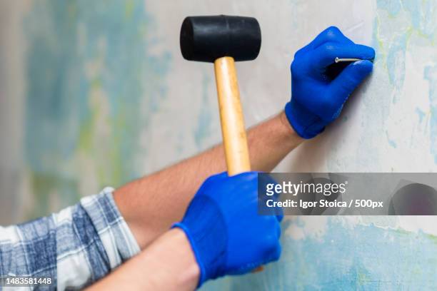 cropped hand of man painting wall,romania - avid pro tools stock pictures, royalty-free photos & images