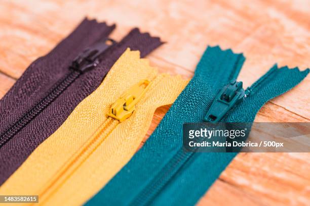 high angle view of colorful fabrics on table - zip foto e immagini stock