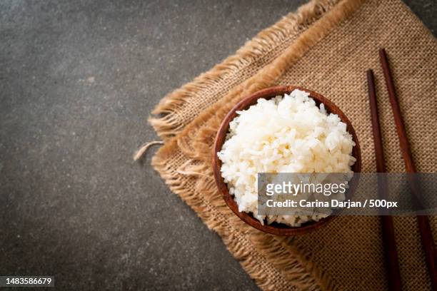 high angle view of rice in bowl on table,romania - rice grains stock pictures, royalty-free photos & images