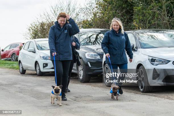 Handlers and dogs from Battersea Dogs Home attend the funeral of Paul O'Grady on April 20, 2023 in Aldington, England. The British entertainer, known...