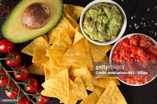 guacamole with bread and avocado on stone background - nachos guacamole stock pictures, royalty-free photos & images