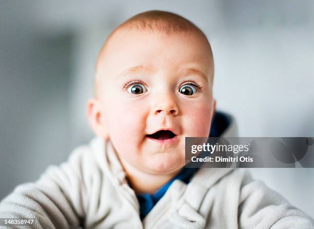 portrait of baby with funny, surprised expression - portrait baby photos et images de collection