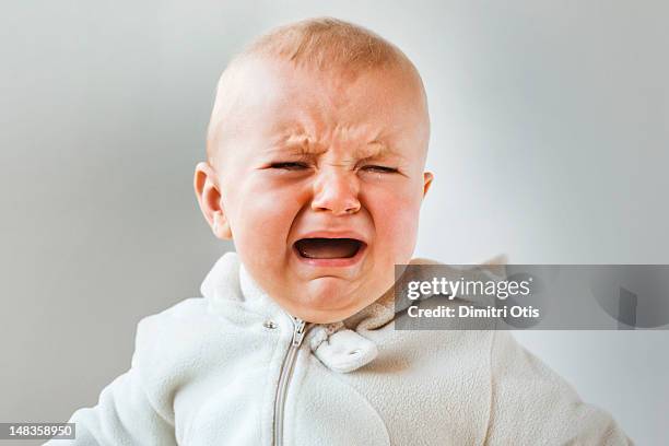 baby crying, screaming and howling, close-up - pianto foto e immagini stock