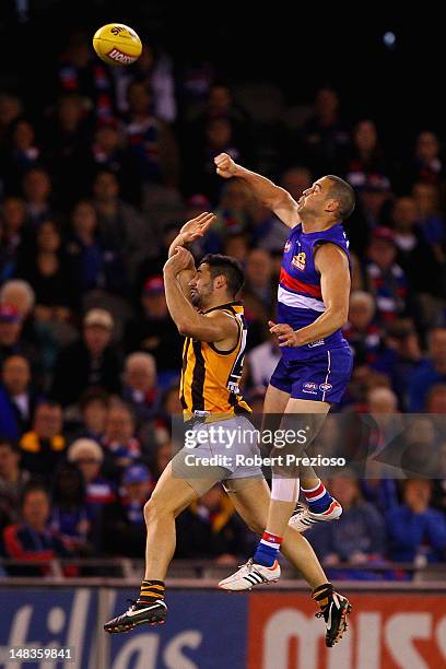 Lindsay Gilbee of the Bulldogs spoils from behind during the round 16 AFL match between the Western Bulldogs and the Hawthorn Hawks at Etihad Stadium...