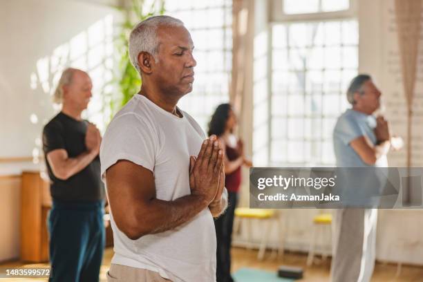 yoga participants following instructions and postures during class - yoga prop stock pictures, royalty-free photos & images